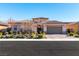 Single-story house with a gray garage door and well-manicured landscaping at 270 Besame Ct, Las Vegas, NV 89138