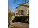Charming home exterior showcasing neutral tones, wooden shutters, and manicured greenery at 312 N Royal Ascot Dr, Las Vegas, NV 89144