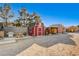 View of multiple barns on the property, including a red barn at 5353 Dorrell Ln, Las Vegas, NV 89131