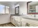 Bright bathroom featuring double sinks and beige cabinets at 5353 Dorrell Ln, Las Vegas, NV 89131