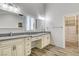 Elegant bathroom with double vanity, walk-in closet, and grey countertops at 5353 Dorrell Ln, Las Vegas, NV 89131