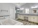 Luxurious bathroom with double vanity, soaking tub, and walk-in shower at 5353 Dorrell Ln, Las Vegas, NV 89131