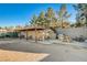 A rustic bunkhouse with chairs and a picnic table on a patio at 5353 Dorrell Ln, Las Vegas, NV 89131