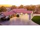 Beautiful home featuring a red tile roof, paved driveway, and covered carport with exterior lighting at 5353 Dorrell Ln, Las Vegas, NV 89131