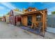 A small wooden livery building with rocking chair on a patio at 5353 Dorrell Ln, Las Vegas, NV 89131