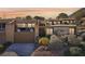 Tan two-story home with balcony and desert landscaping at 536 Woodcrest Dr, Boulder City, NV 89005