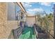 Private patio with artificial turf, gardening space, and storage at 536 Woodcrest Dr, Boulder City, NV 89005