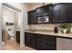 Small bathroom with toilet, shower, and dark brown cabinets at 5455 San Florentine Ave, Las Vegas, NV 89141