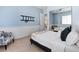 Spacious bedroom with a queen bed, built-in mirror closet, and sitting chair at 5455 San Florentine Ave, Las Vegas, NV 89141