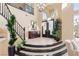 Elegant foyer with soaring ceilings, chandelier, curved staircase, and tile flooring at 5455 San Florentine Ave, Las Vegas, NV 89141