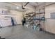 Organized garage with overhead storage, wall shelving, and epoxy flooring at 5455 San Florentine Ave, Las Vegas, NV 89141