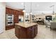 Open-concept kitchen with stainless steel appliances, granite countertops, and seamless flow to the living area at 5455 San Florentine Ave, Las Vegas, NV 89141