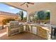 Outdoor kitchen with stainless steel appliances and stone counters at 5455 San Florentine Ave, Las Vegas, NV 89141