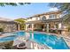 Inviting backyard pool and spa with covered patio, seating, and outdoor bar area at 5455 San Florentine Ave, Las Vegas, NV 89141