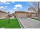 Single-story house with a two-car garage and landscaped front yard at 5697 Crowbush Cove Pl, Las Vegas, NV 89122