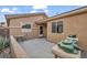 Inviting front patio with small table and chairs, and decorative frog statues at 5697 Crowbush Cove Pl, Las Vegas, NV 89122