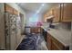 Galley kitchen with wood cabinets and appliances at 5697 Crowbush Cove Pl, Las Vegas, NV 89122