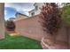 Artificial turf backyard with sandbox and trees at 5835 Rustic Prairie St, Las Vegas, NV 89148