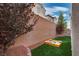 Landscaped backyard with sandbox and artificial turf at 5835 Rustic Prairie St, Las Vegas, NV 89148