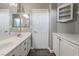 Bathroom with double vanity, white cabinets, and updated flooring at 6010 Garthmore, Las Vegas, NV 89141