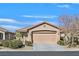 Single-story home with a two-car garage and desert landscaping at 6072 Isola Peak Ave, Las Vegas, NV 89122