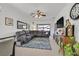 Spacious living room with sectional sofa, large TV, and area rug at 6072 Isola Peak Ave, Las Vegas, NV 89122