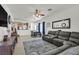 Living room with sectional sofa, dining area, and kitchen view at 6072 Isola Peak Ave, Las Vegas, NV 89122