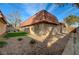 Single story home with a terracotta tile roof and a small, landscaped yard at 6413 Ironbark Ln, Las Vegas, NV 89107