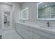 Bright bathroom boasts double sinks, LED backlit mirrors, and a large shower at 6788 Lavender Sky Ct, Las Vegas, NV 89142