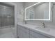 Modern bathroom with a double vanity, illuminated mirror, and shower/tub combo at 6788 Lavender Sky Ct, Las Vegas, NV 89142
