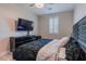 Bright bedroom with a large TV and comfortable bed at 6788 Lavender Sky Ct, Las Vegas, NV 89142