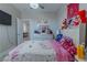 bedroom with a unicorn-themed bedspread and plenty of toys at 6788 Lavender Sky Ct, Las Vegas, NV 89142