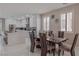 Open concept dining area with modern table and chairs, adjacent to a kitchen at 6788 Lavender Sky Ct, Las Vegas, NV 89142