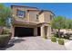 Two-story house with a black garage door and landscaped front yard at 6788 Lavender Sky Ct, Las Vegas, NV 89142