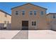 Tan two-story house with dark brown double doors at 6788 Lavender Sky Ct, Las Vegas, NV 89142