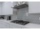 Modern kitchen features stainless steel appliances and a herringbone backsplash at 6788 Lavender Sky Ct, Las Vegas, NV 89142