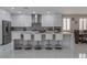 Modern kitchen with white cabinets, stainless steel appliances, and breakfast bar at 6788 Lavender Sky Ct, Las Vegas, NV 89142