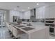Modern kitchen with white cabinets, stainless steel appliances, and an island with seating at 6788 Lavender Sky Ct, Las Vegas, NV 89142