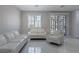 Bright living room with white sofas and access to a patio at 6788 Lavender Sky Ct, Las Vegas, NV 89142
