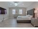 Spacious main bedroom with a large bed, hardwood floors, and plenty of natural light at 6788 Lavender Sky Ct, Las Vegas, NV 89142