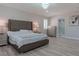 Elegant main bedroom with a king-size bed, en-suite bathroom access, and stunning art at 6788 Lavender Sky Ct, Las Vegas, NV 89142