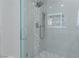 Clean and modern shower with hexagonal tile and glass enclosure at 6788 Lavender Sky Ct, Las Vegas, NV 89142