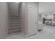 Modern staircase with wood steps and white risers at 6788 Lavender Sky Ct, Las Vegas, NV 89142