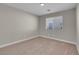 Well-lit bedroom featuring neutral walls and carpet at 6993 Silk Oak Ct, Las Vegas, NV 89148