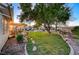 Landscaped backyard with a large grassy area and a pergola at 7015 N Jensen St, Las Vegas, NV 89149