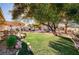 Landscaped backyard with expansive lawn and mature trees at 7015 N Jensen St, Las Vegas, NV 89149