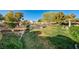Spacious backyard with green lawn, mature trees, and landscaping at 7015 N Jensen St, Las Vegas, NV 89149