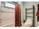 Bathroom with shower/tub combo, toilet, and decorative curtain at 7015 N Jensen St, Las Vegas, NV 89149