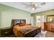 Bedroom with dresser, ceiling fan, and en-suite bathroom access at 7015 N Jensen St, Las Vegas, NV 89149