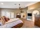 Main bedroom with king-size bed, ceiling fan, and access to the bathroom at 7015 N Jensen St, Las Vegas, NV 89149